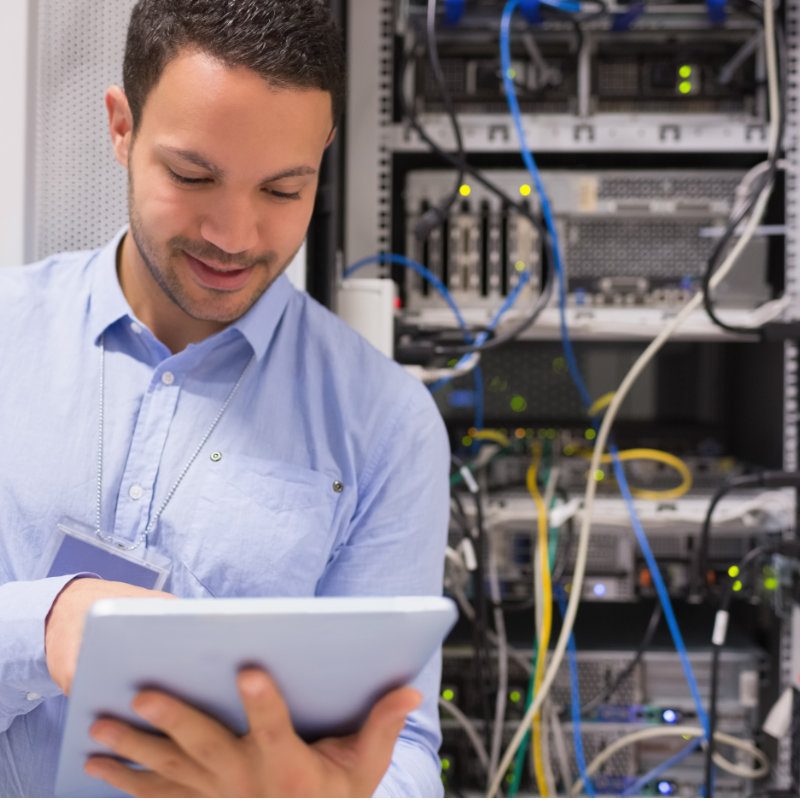Data centre worker with tablet computer in data centre